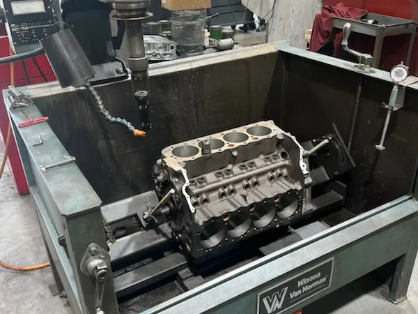 Winona Van Norman BE 3301 Auto Hone with an engine block